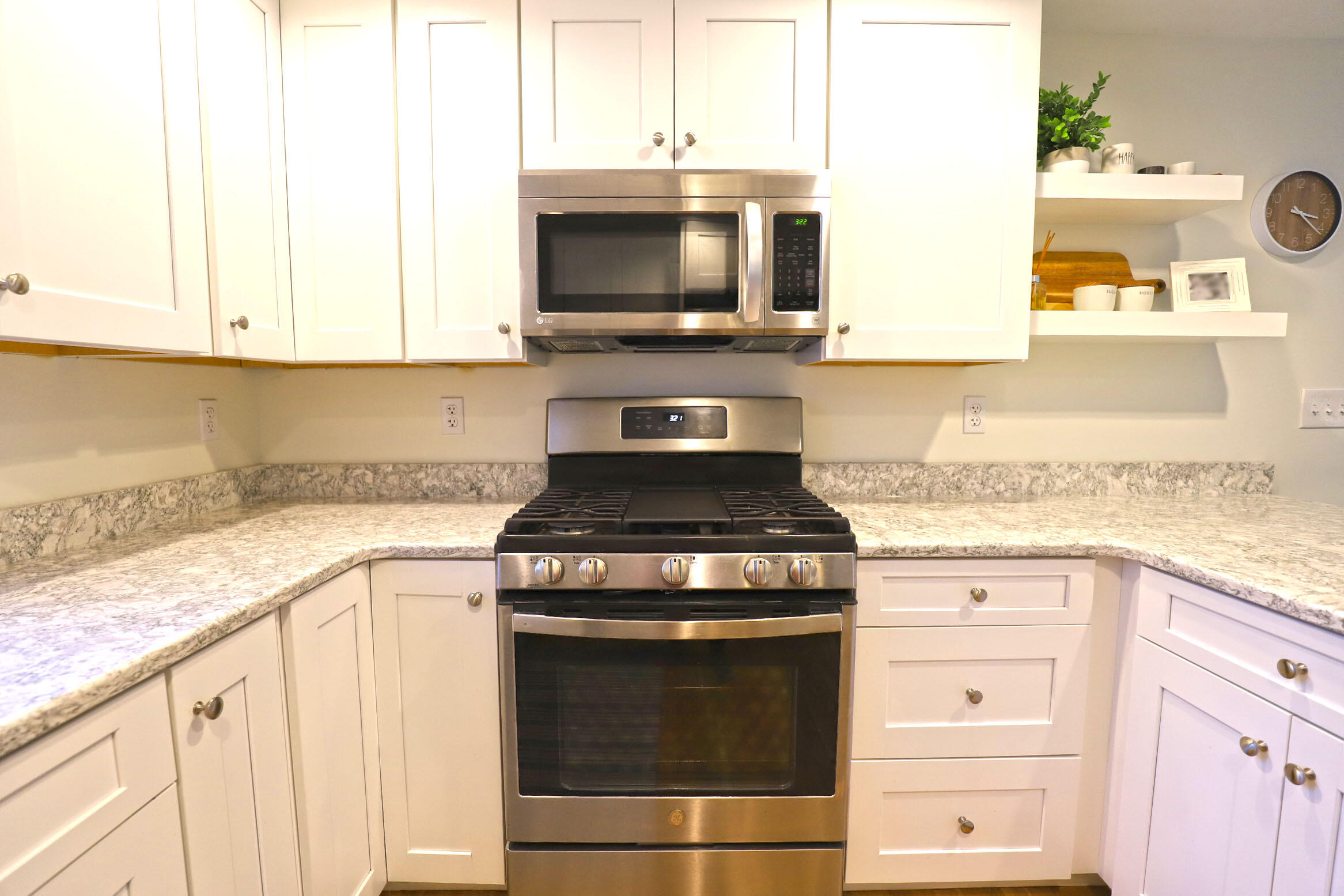50 Jackson Drive Cotuit, MA 02635 - Photo 14 of 30 a kitchen with granite countertop white cabinets and appliances