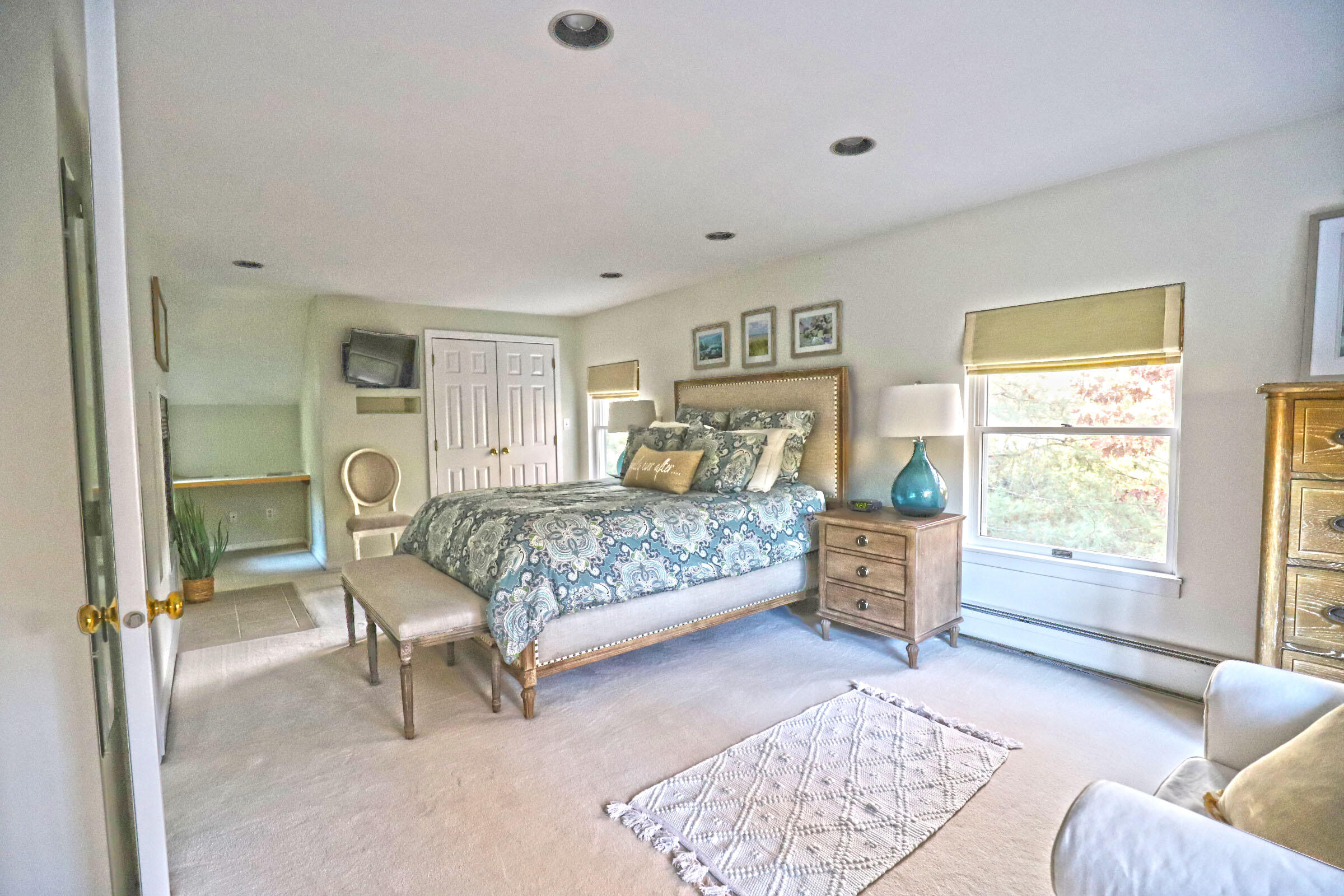 50 Jackson Drive Cotuit, MA 02635 - Photo 24 of 30 a bedroom with a bed and a couch next to a window