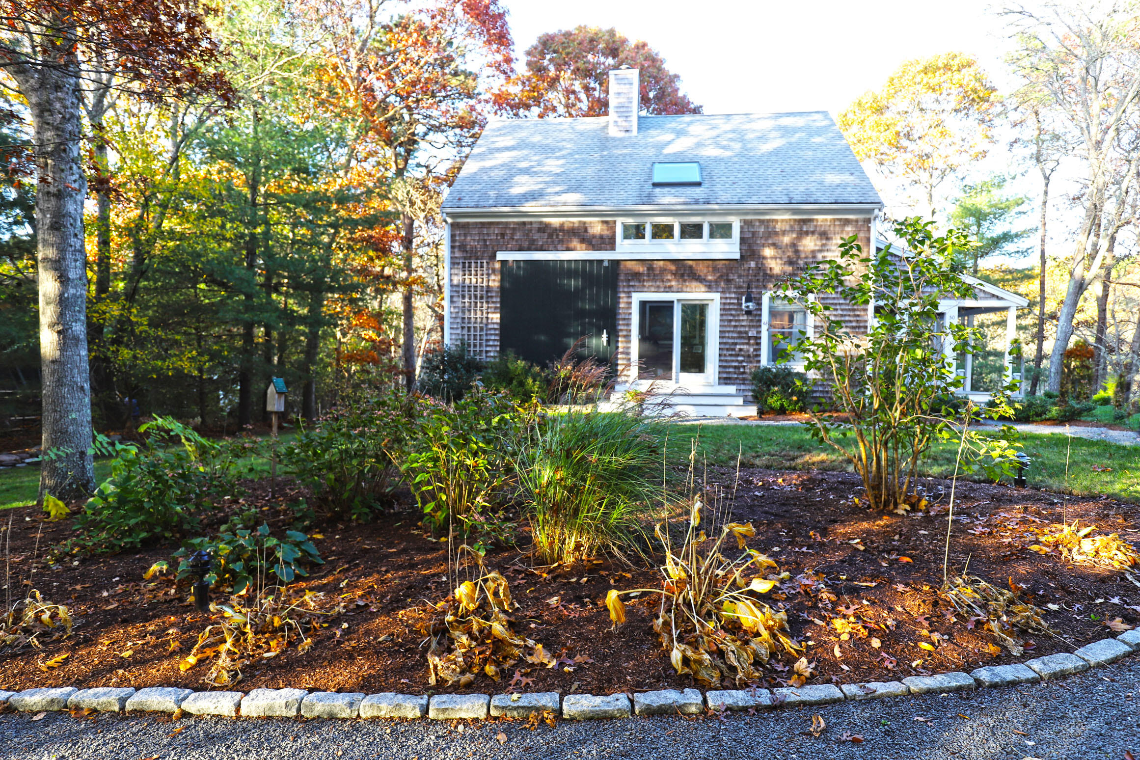 50 Jackson Drive Cotuit, MA 02635 - Photo 5 of 30 front view of a house with a garden