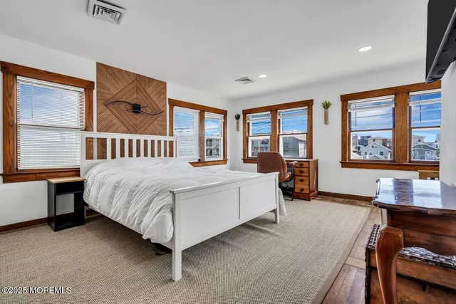 a bedroom with a bed and a large window