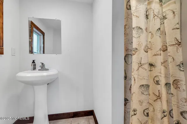 a kitchen with stainless steel appliances granite countertop a sink a stove a dining table and chairs with wooden floor