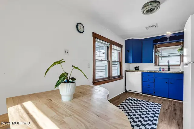 a kitchen with a window wooden cabinets and a sink