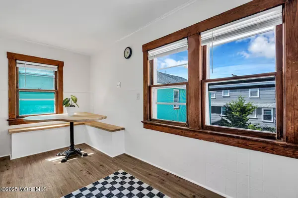 a view of staircase with wooden floor and a window