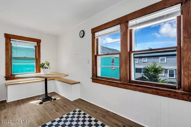 a view of staircase with wooden floor and a window