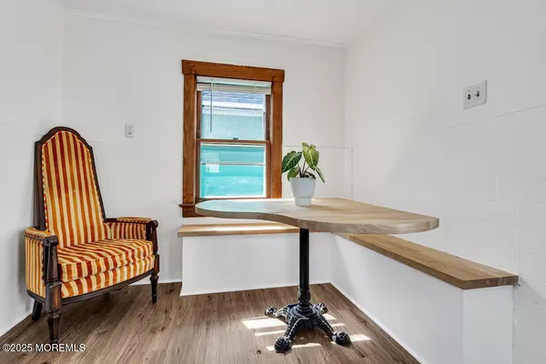 a view of a hallway with wooden floor and a potted plant