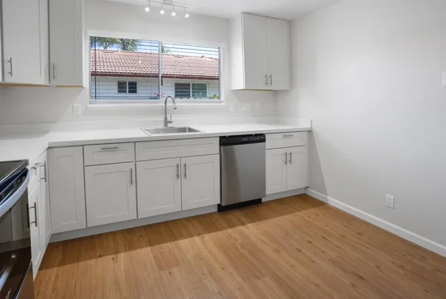 a kitchen with sink cabinets and window