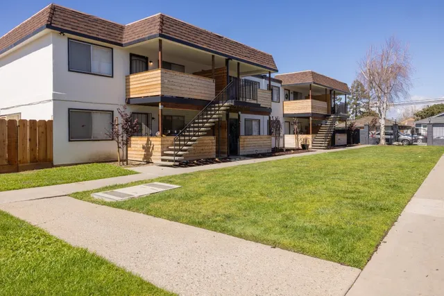 a view of a house with a yard and a garage