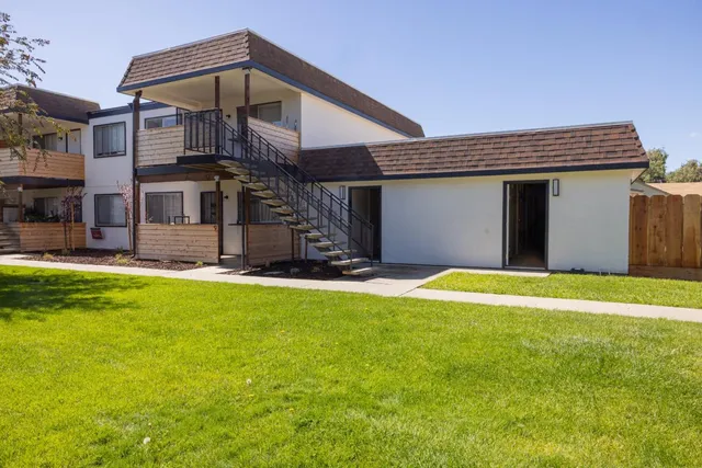 a view of a house with pool and a yard