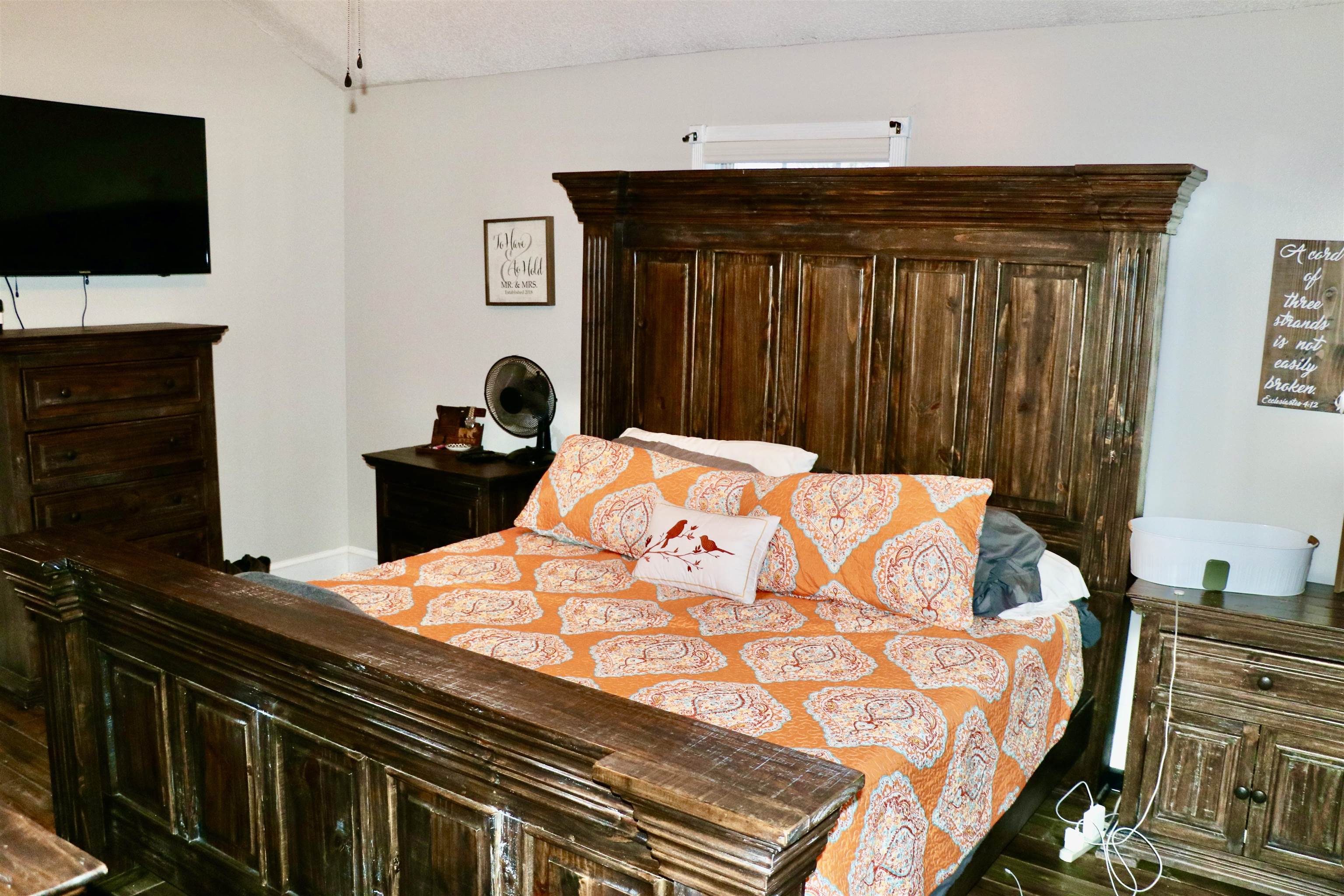 235 Tate Road Dyersburg, TN 38024 - Photo 11 of 28 a bedroom with a bed and a flat screen tv