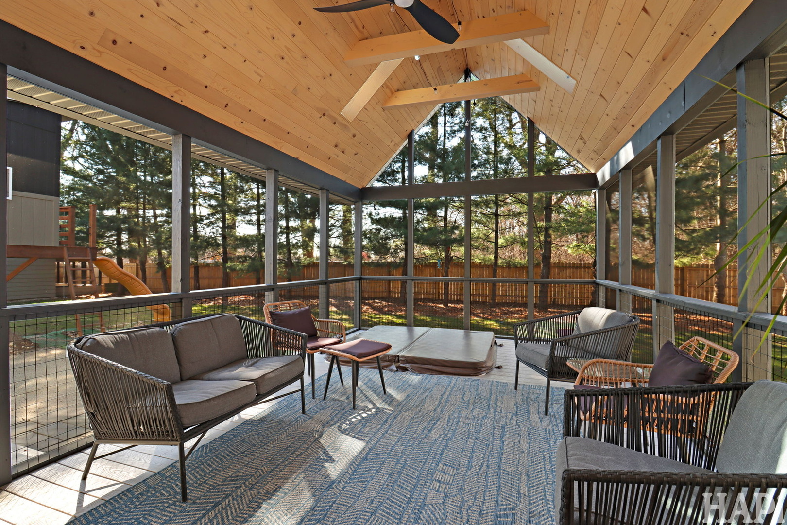 4321 West Lakewood Road McHenry, IL 60050 - Photo 14 of 51 a balcony with wooden benches and a couch