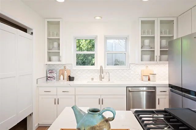 a kitchen with a refrigerator and cabinets