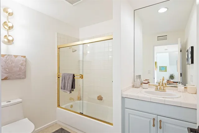 a bedroom with a bed and a view of bathroom