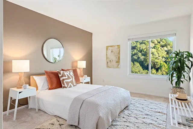 a bedroom with a large bed and a large window