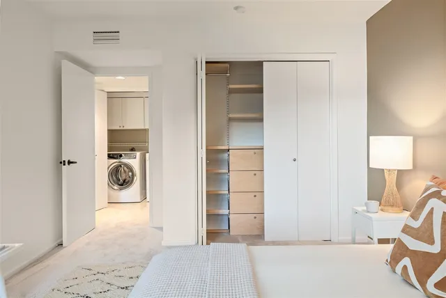 a bedroom with a bed and a chair