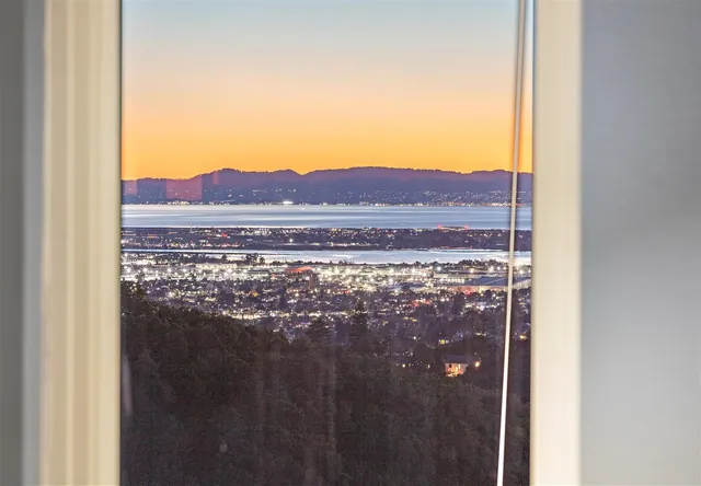 a view of mountain with sunset in background
