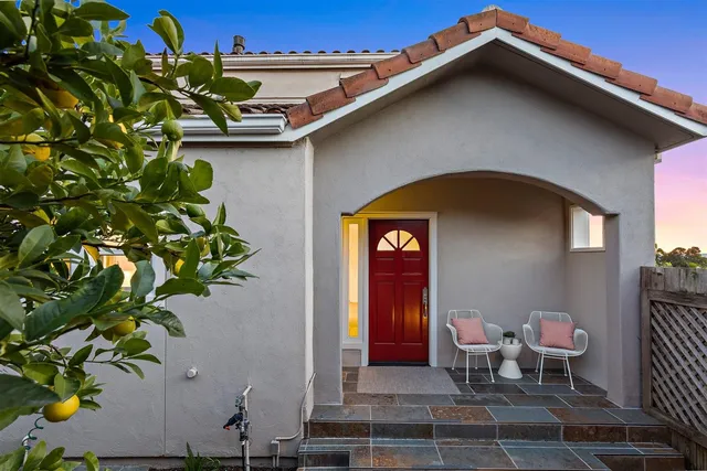 a blue and white vase with flowers sitting on a table