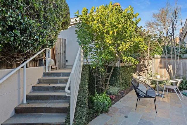 a view of a room with furniture and wooden door