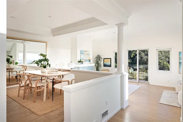 a living room with furniture and large windows