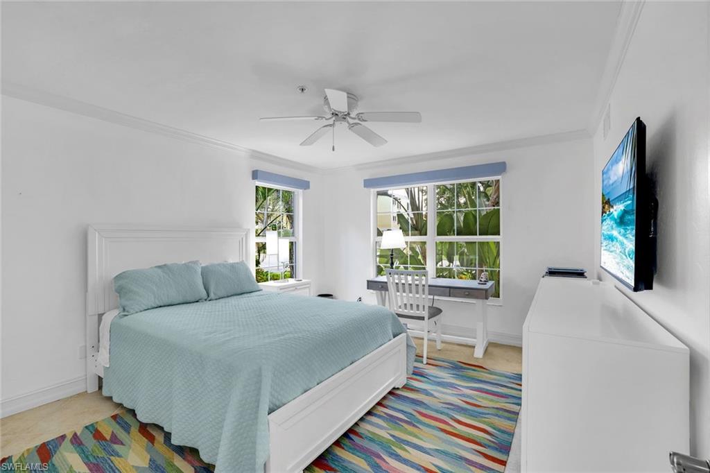 376 3rd Street South, Unit 102 Naples, FL 34102 - Photo 14 of 17 Bedroom with ornamental molding and a ceiling fan