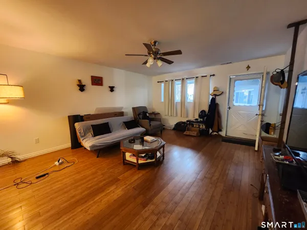 a living room with furniture and a flat screen tv