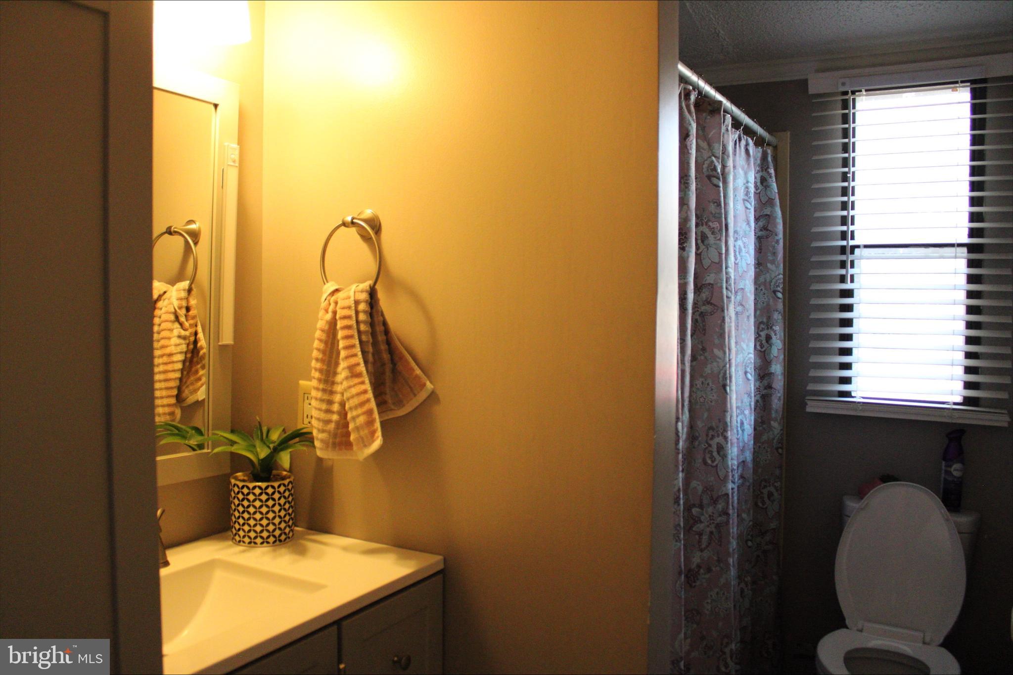 1061 South Little Creek Road, Unit 200 Dover, DE 19901 - Photo 14 of 21 a bathroom with a granite countertop sink and a mirror