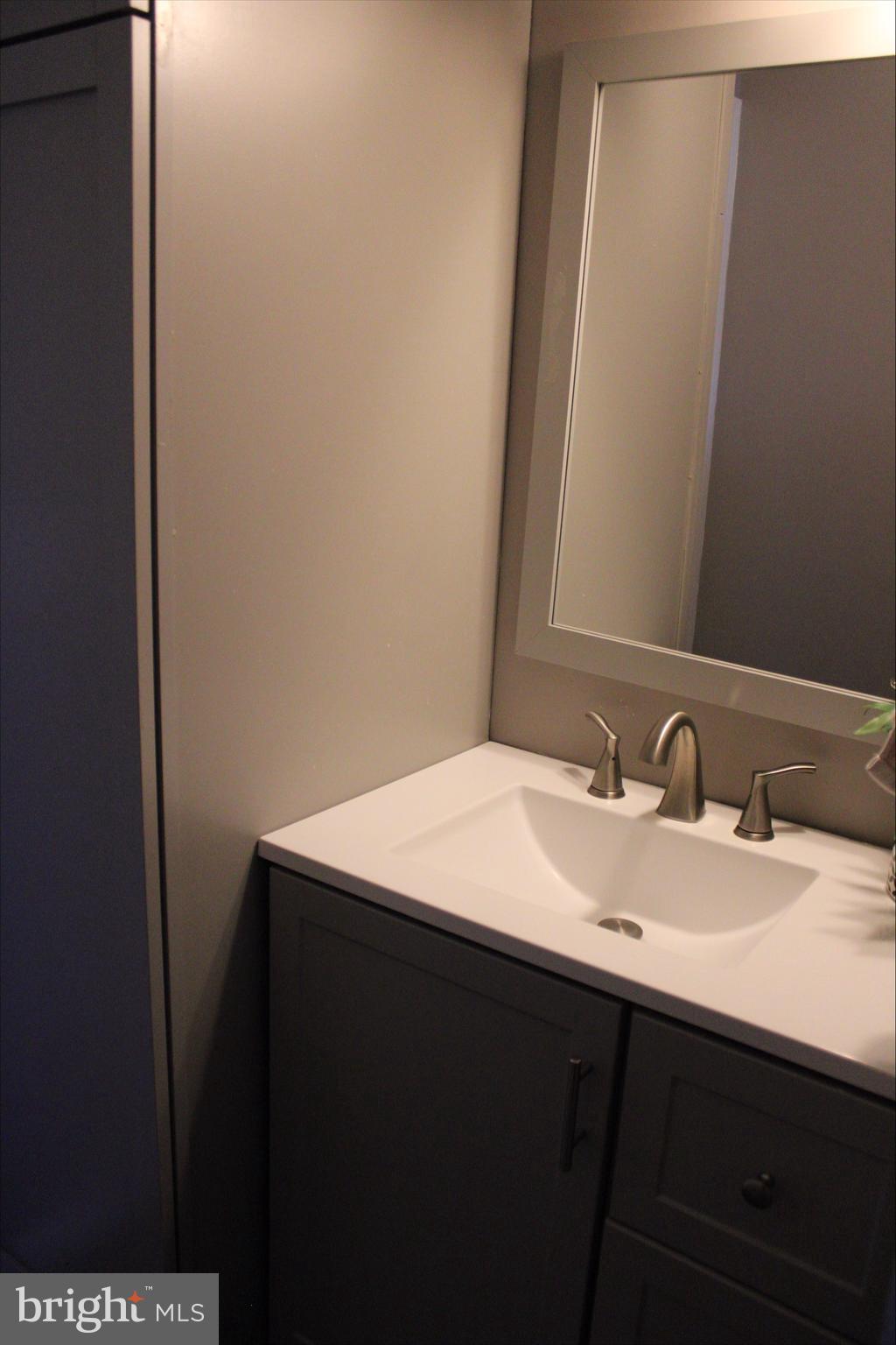 1061 South Little Creek Road, Unit 200 Dover, DE 19901 - Photo 15 of 21 a bathroom with a sink and a mirror