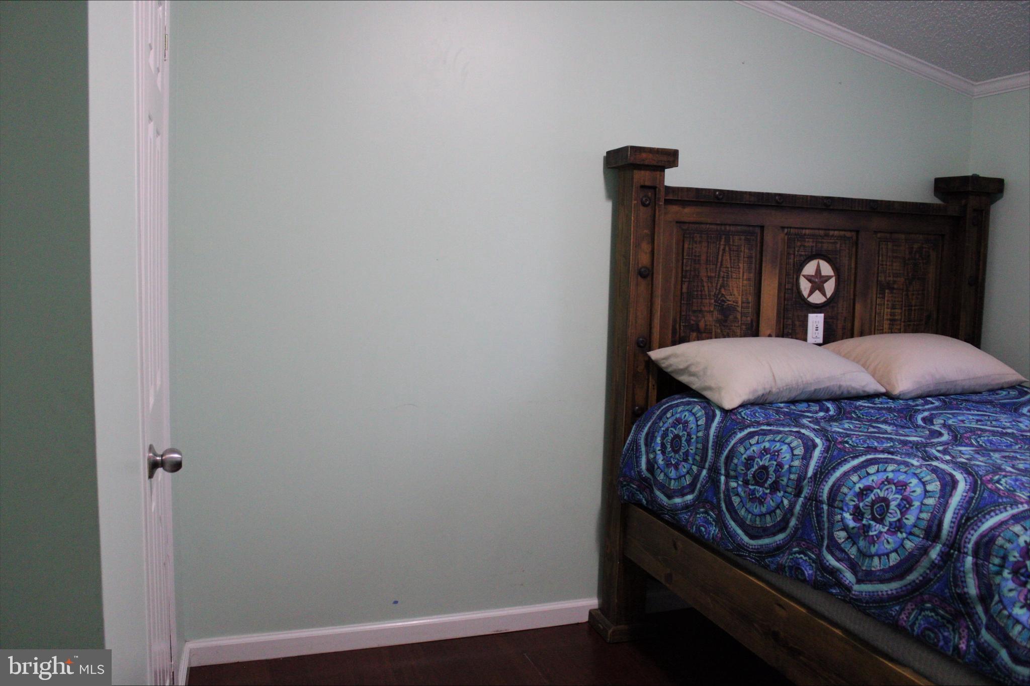 1061 South Little Creek Road, Unit 200 Dover, DE 19901 - Photo 18 of 21 a bedroom with a bed and a window