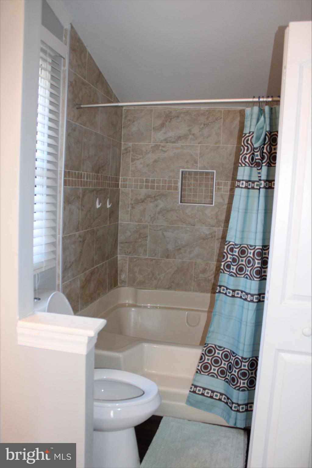1061 South Little Creek Road, Unit 200 Dover, DE 19901 - Photo 9 of 21 a bathroom with a bathtub and a shower