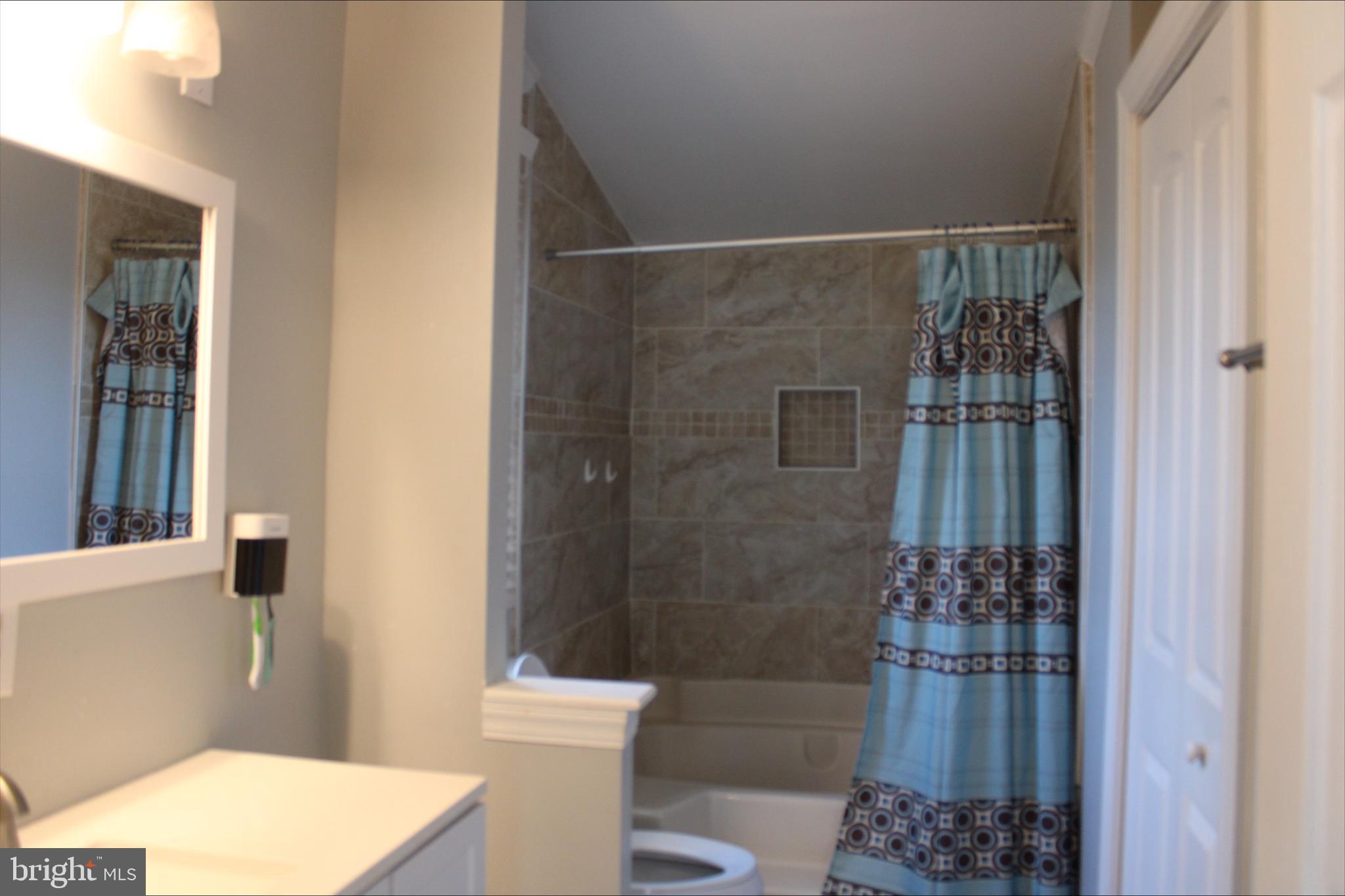 1061 South Little Creek Road, Unit 200 Dover, DE 19901 - Photo 10 of 21 a bathroom with a toilet and shower