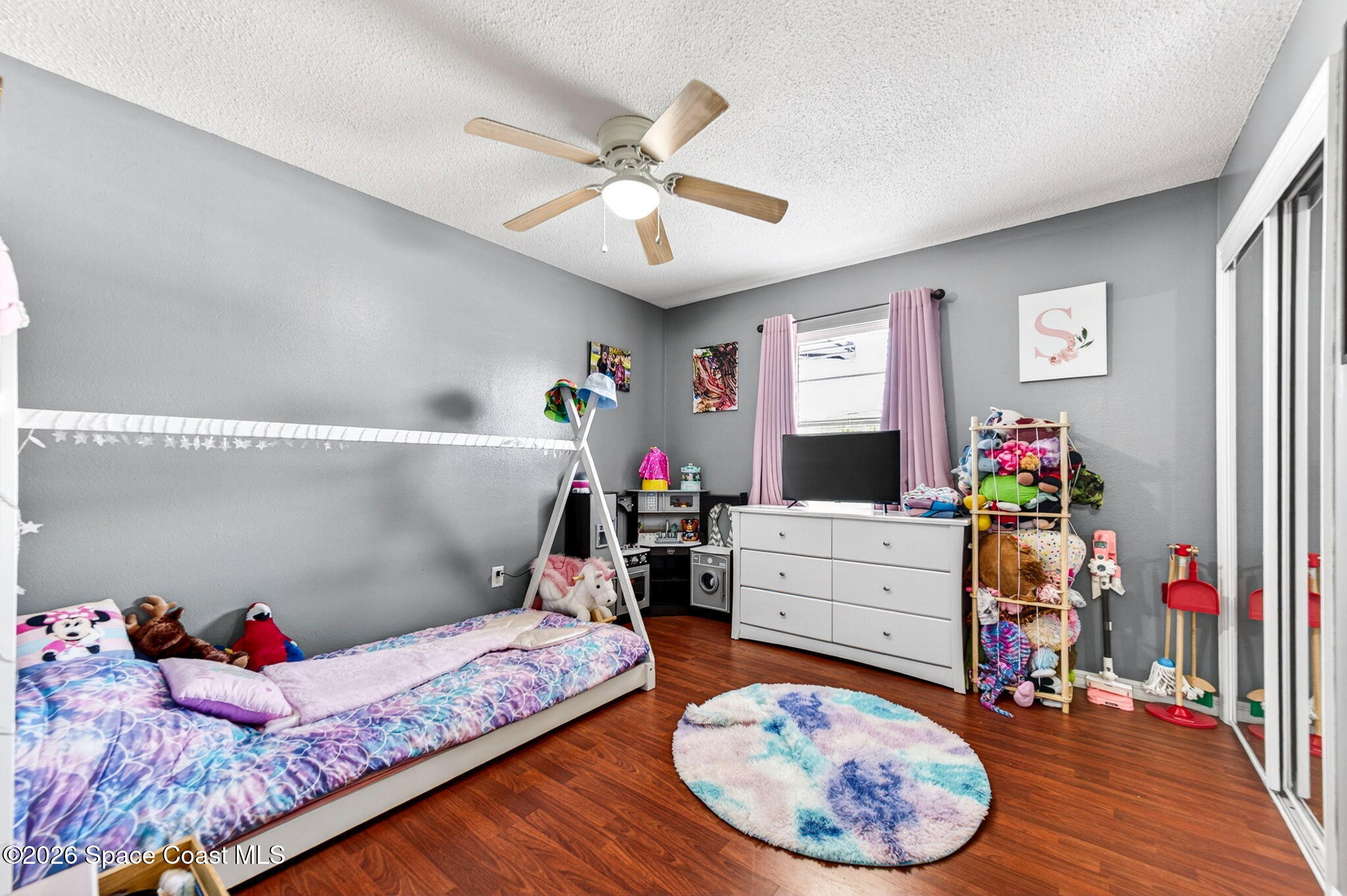 3300 Argyle Road Titusville, FL 32796 - Photo 16 of 29 a bed room with a bed and a chandelier
