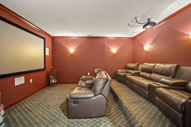 an aerial view of a house with a yard and large trees