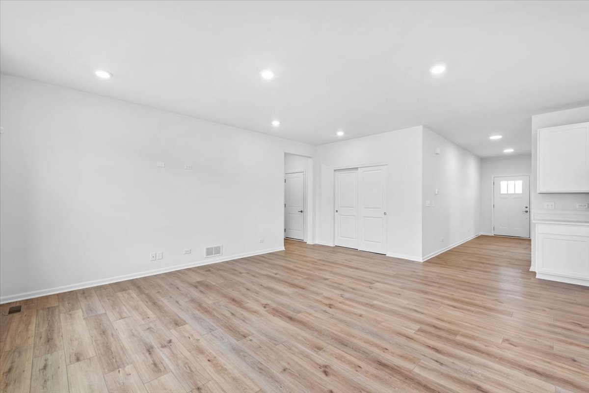 87 Hedgerow Drive Elgin, IL 60124 - Photo 13 of 52 a view of an empty room with wooden floor