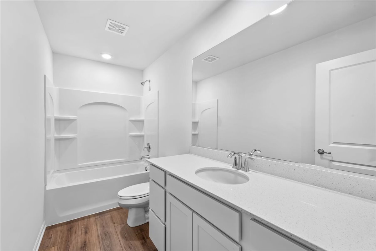 87 Hedgerow Drive Elgin, IL 60124 - Photo 26 of 52 a bathroom with a granite countertop sink toilet a shower and a bathtub