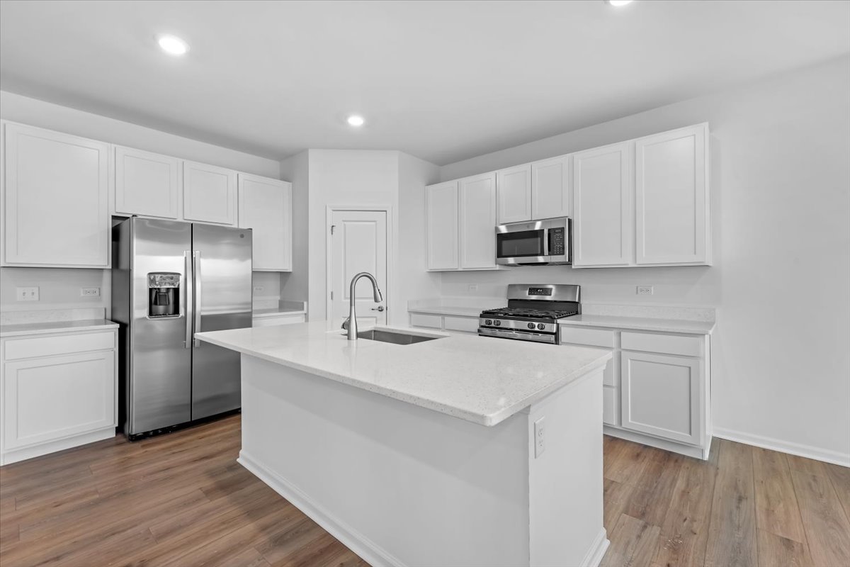 87 Hedgerow Drive Elgin, IL 60124 - Photo 8 of 52 a kitchen with stainless steel appliances granite countertop a refrigerator stove microwave and sink