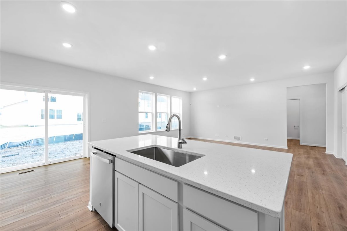 87 Hedgerow Drive Elgin, IL 60124 - Photo 9 of 52 a kitchen with a sink and wooden floor
