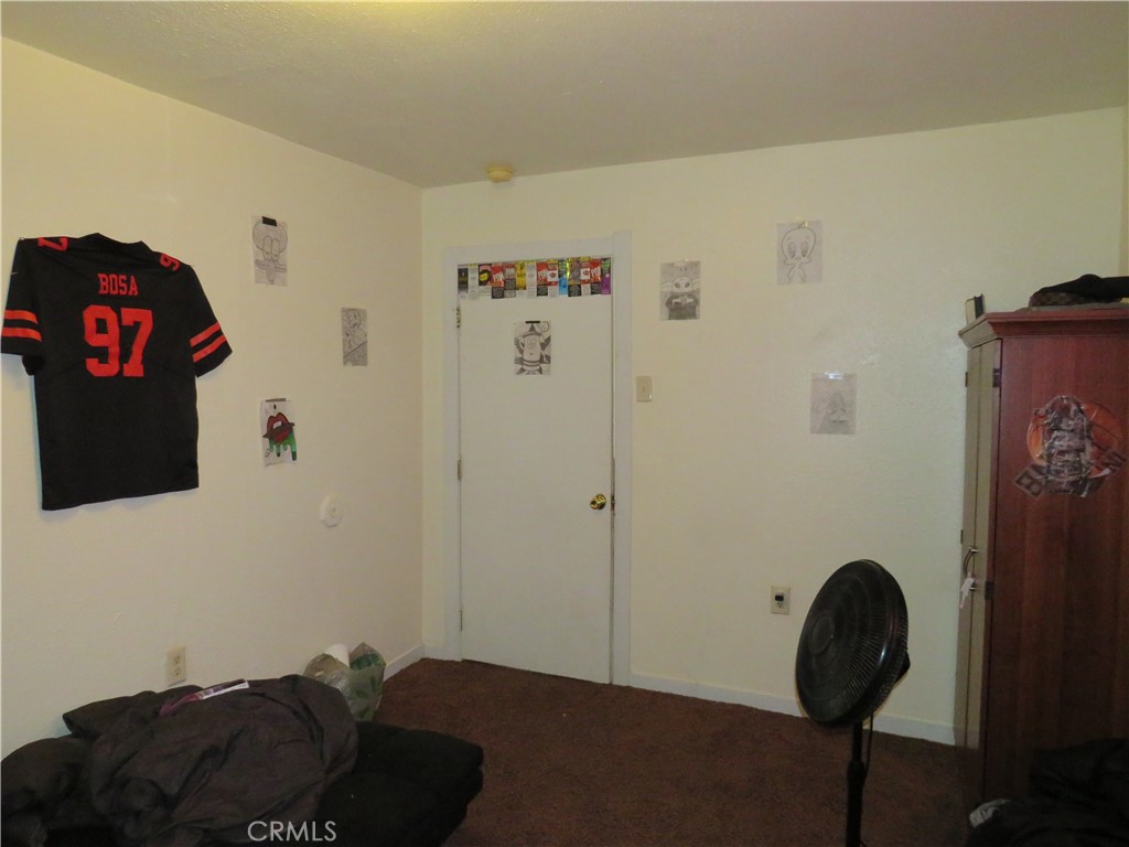 312 West Cedar Street Willows, CA 95988 - Photo 16 of 21 a bedroom with a bed and a painting on the wall