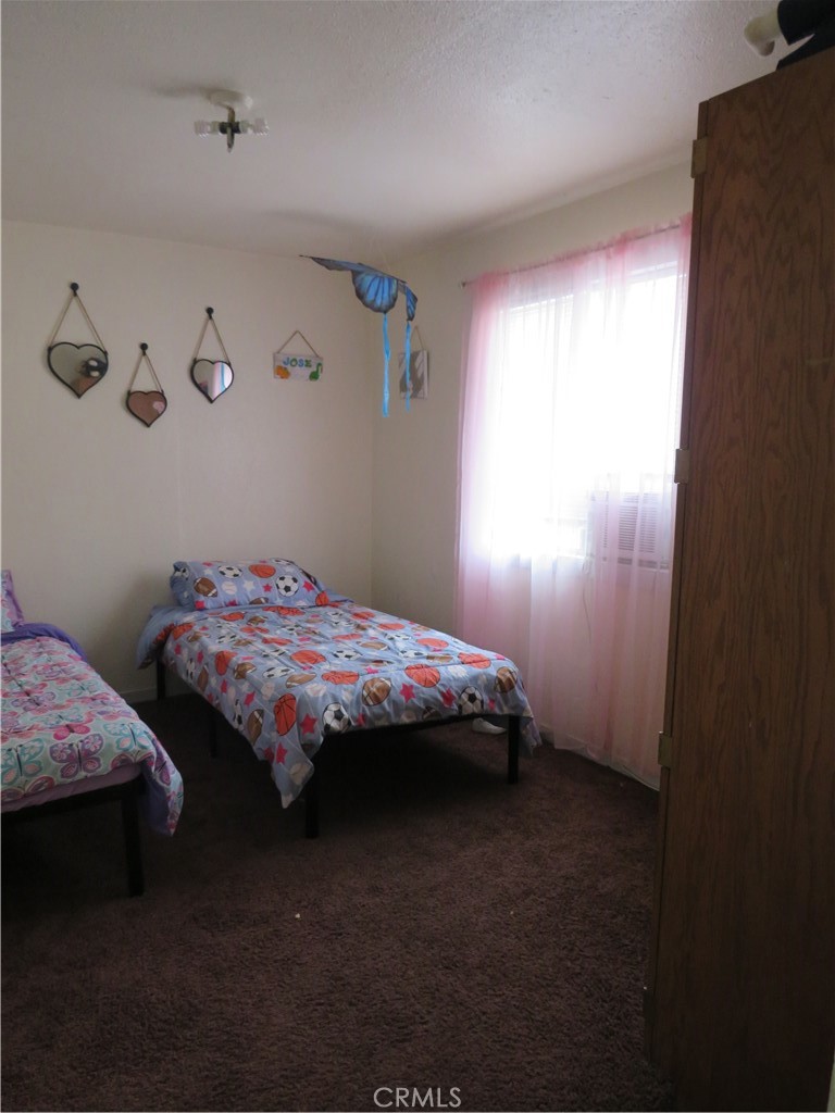 312 West Cedar Street Willows, CA 95988 - Photo 17 of 21 a bedroom with bed and window