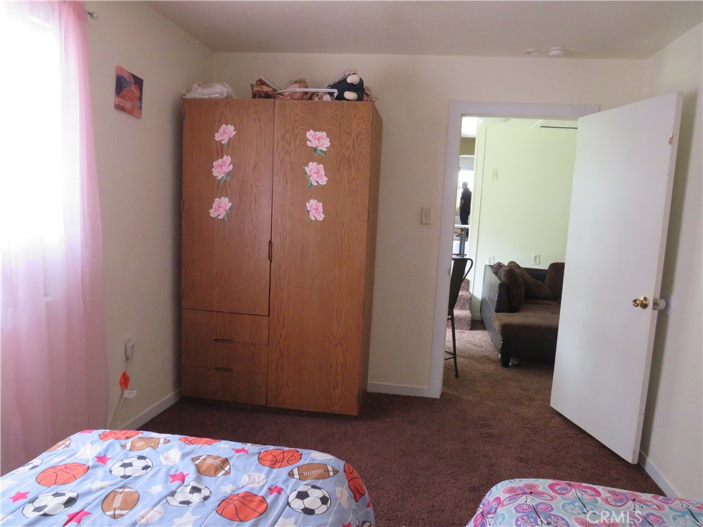 312 West Cedar Street Willows, CA 95988 - Photo 18 of 21 a bedroom with a bed and a couch