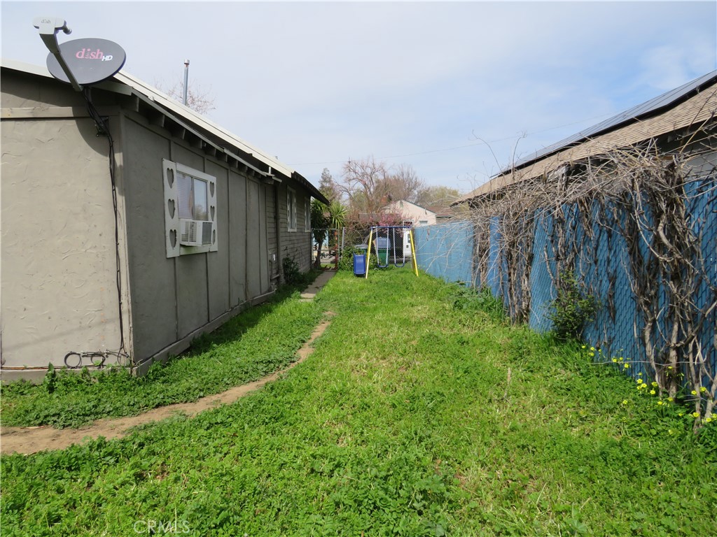 312 West Cedar Street Willows, CA 95988 - Photo 21 of 21 a backyard of a house with lots of green space and plants