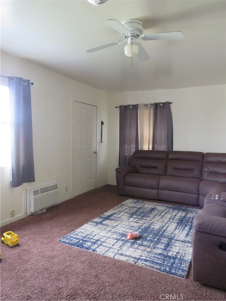 312 West Cedar Street Willows, CA 95988 - Photo 3 of 21 a living room with couches and kitchen view with wooden floor