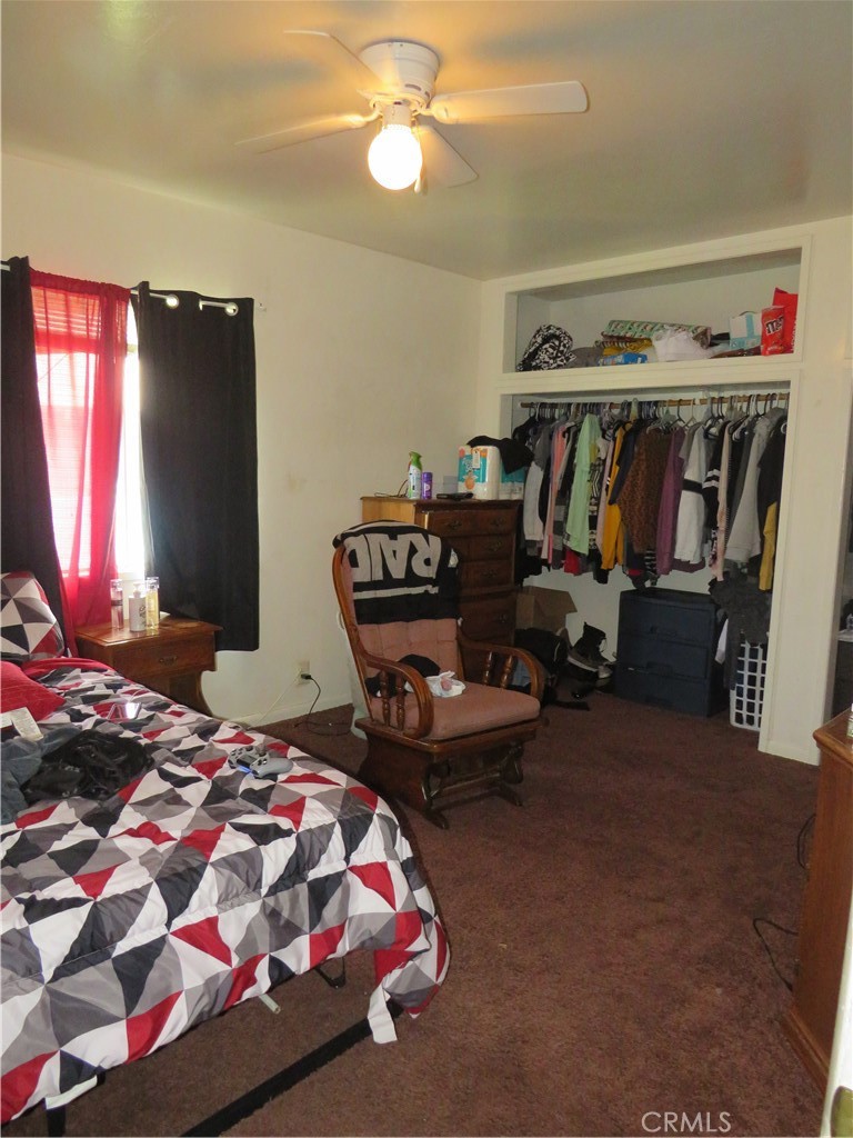 312 West Cedar Street Willows, CA 95988 - Photo 7 of 21 a bedroom with bed and a chandelier