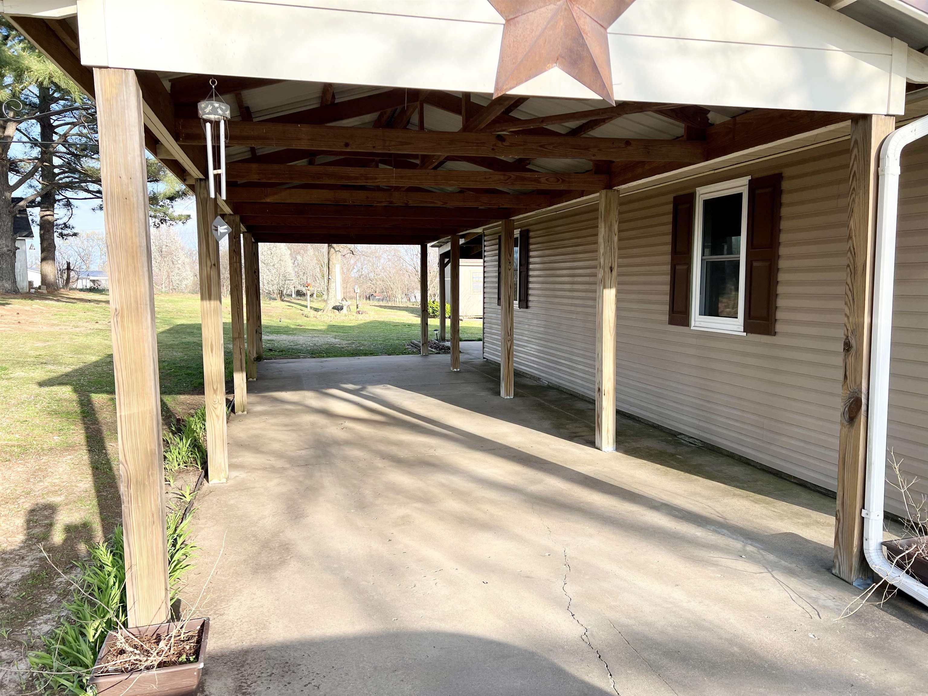 3982 Craig Road Ripley, TN 38063 - Photo 3 of 12 a view of a porch with a table and chairs under an umbrella