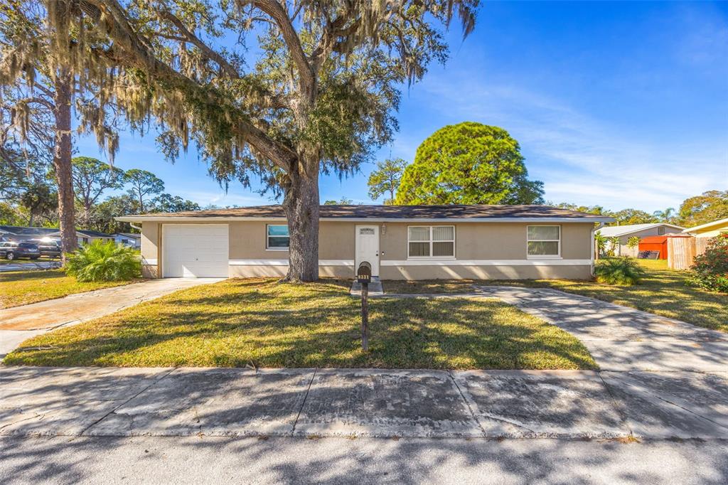 8331 Wilkins Street Port Richey, FL 34668 - Photo 28 of 29 a view of a house with backyard and swimming pool