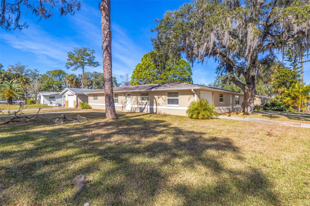 8331 Wilkins Street Port Richey, FL 34668 - Photo 29 of 29 a view of a house with a yard