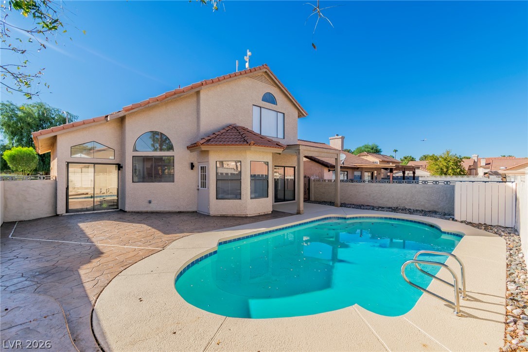 370 Rushing Creek Court Henderson, NV 89014 - Photo 13 of 32 An inviting private pool anchors the low-maintenance backyard patio of this two-story stucco home.