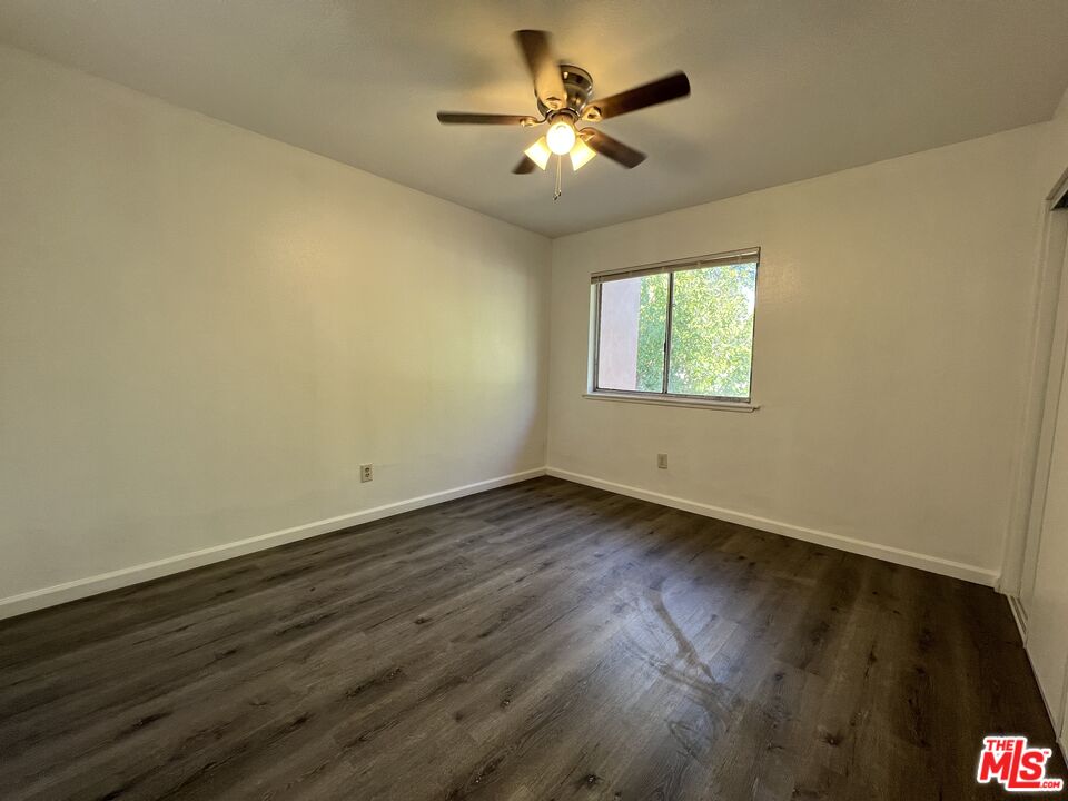 418 West Jackson Street Rialto, CA 92376 - Photo 20 of 24 an empty room with wooden floor and windows