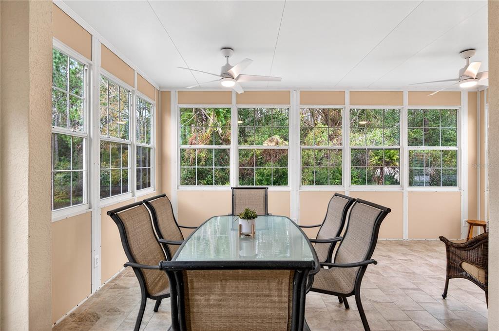 1737 Sassafras Drive Wesley Chapel, FL 33543 - Photo 36 of 58 a view of a dining room with furniture large windows and wooden floor