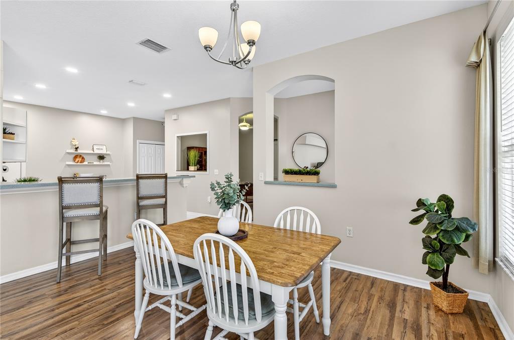 1737 Sassafras Drive Wesley Chapel, FL 33543 - Photo 7 of 58 a view of a dining room with furniture and wooden floor