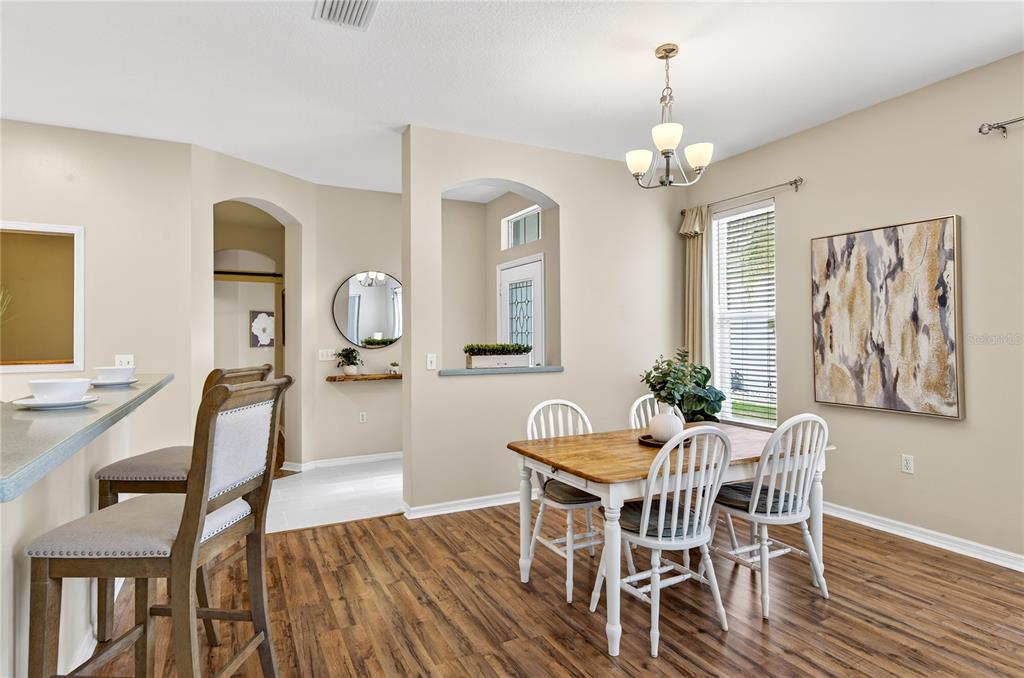 1737 Sassafras Drive Wesley Chapel, FL 33543 - Photo 8 of 58 a view of a dining room with furniture and wooden floor