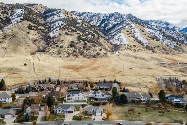 240 Bugle Way Providence, UT 84332 - Photo 13 of 15 Aerial perspective featuring a residential area nestled against a prominent mountain range with snow-dusted peaks